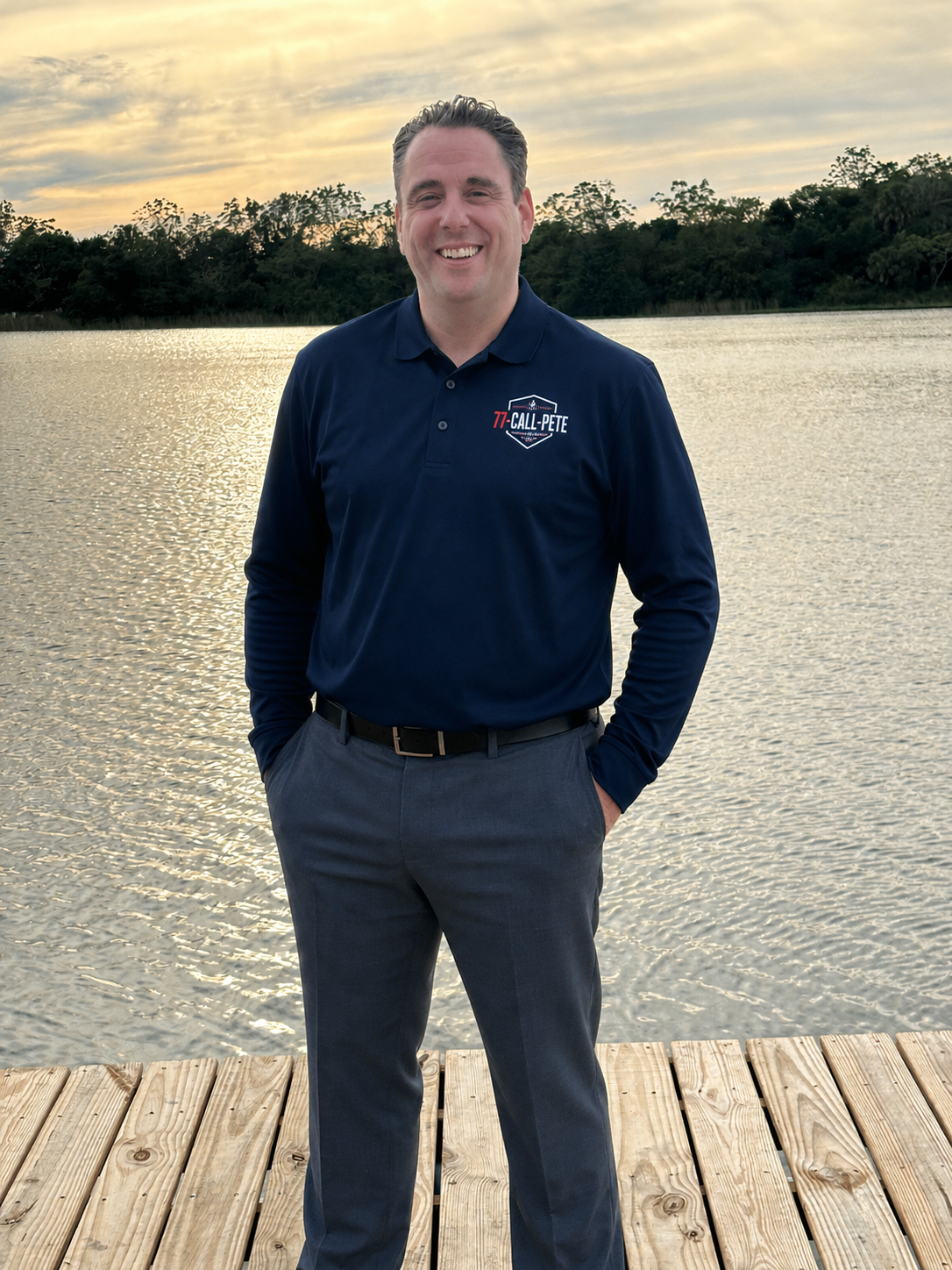Pete wearing a 77-Call-Pete logo shirt while standing by the lake, your local independent health insurance broker helping individuals, families, seniors, and businesses find the right coverage.